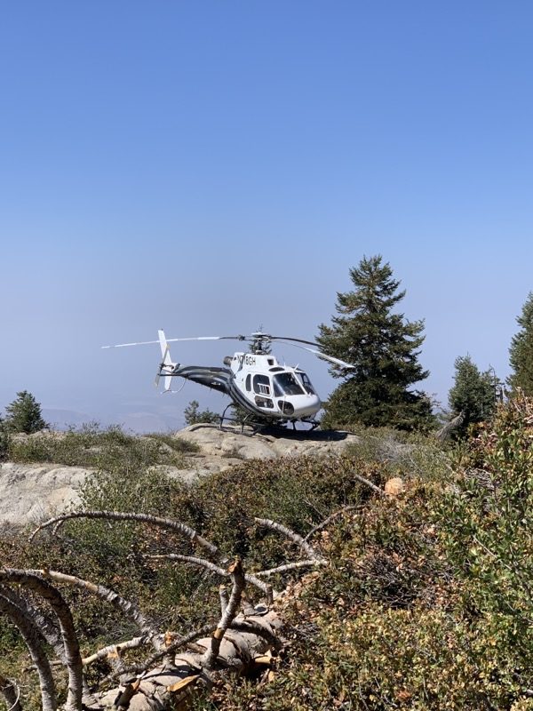 Helicopter landed on a granite outcrop