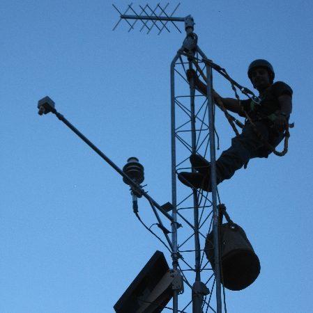 Technician climbing a meteorological tower